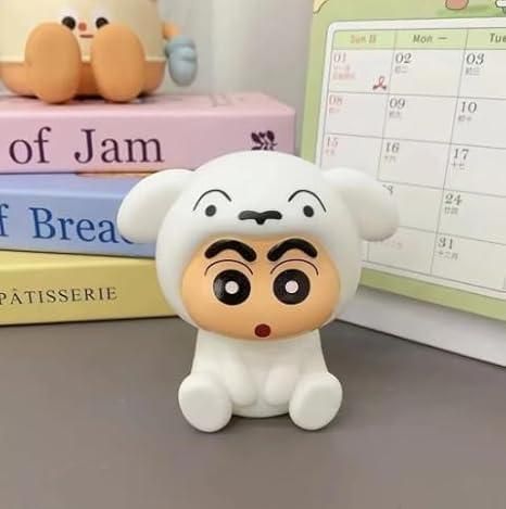 Cute cartoon figurine with a surprised expression on a surface with books and a calendar in the background.