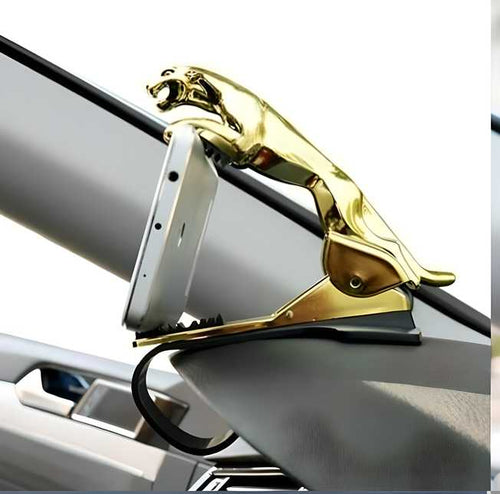 Gold car emblem on a car's hood with a white background